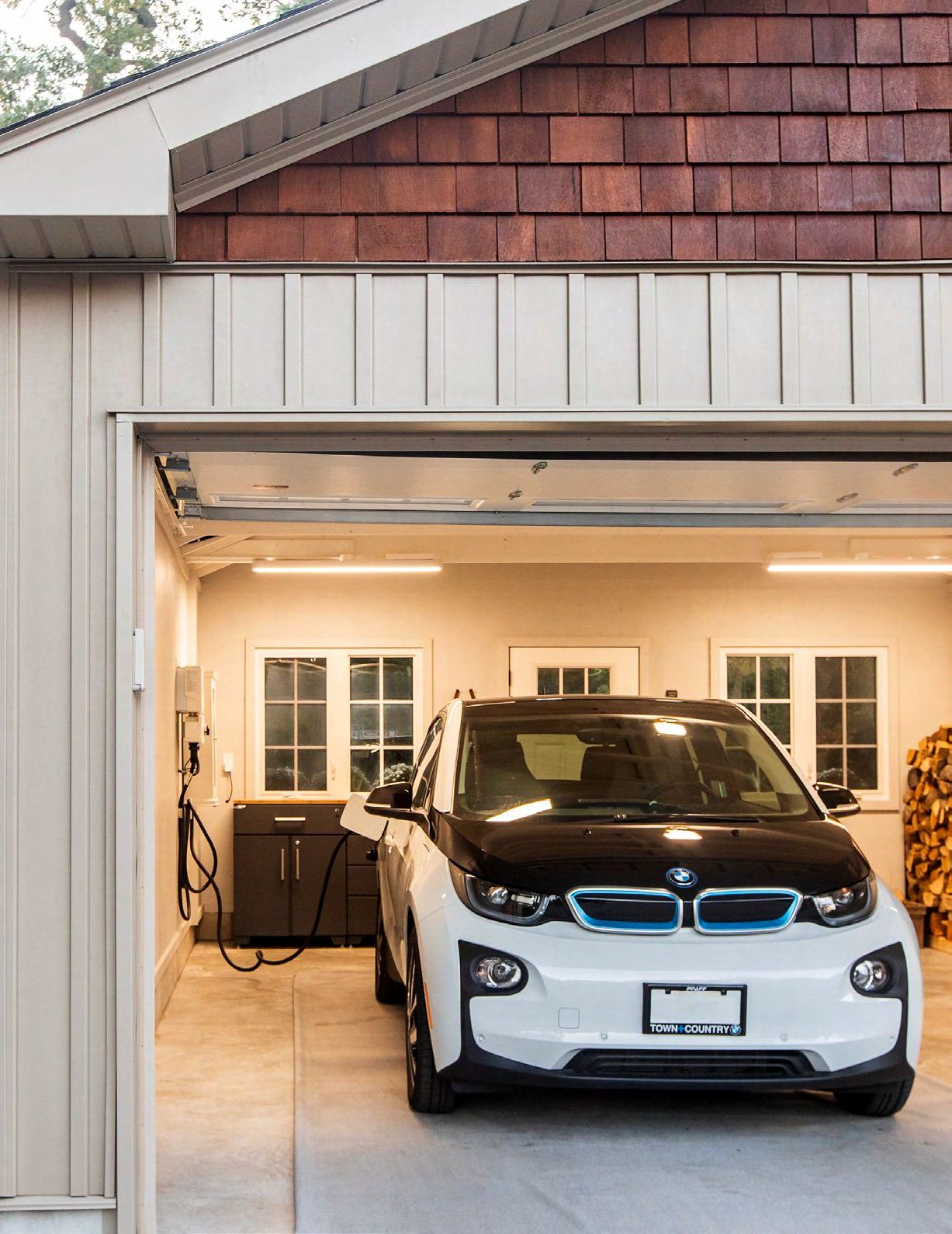 BMW i3 electric vehicle charging in residential garage with home charging station